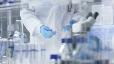 İçinde Modern laboratuvar Yardımcısı getiriyor Petri kabına şef araştırma bilim adamı için kim örnek altında mikroskop inceleyerek başlar.