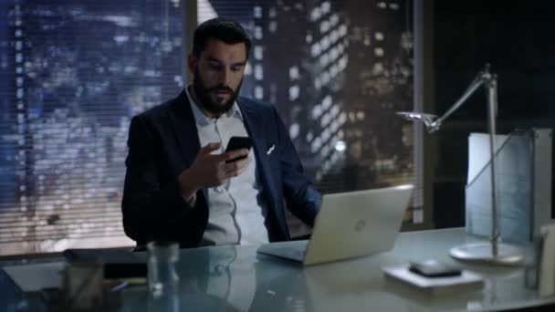 Late at Night Businessman Talks on a Phone in His Private Office with Big City Window View. — Stock Video