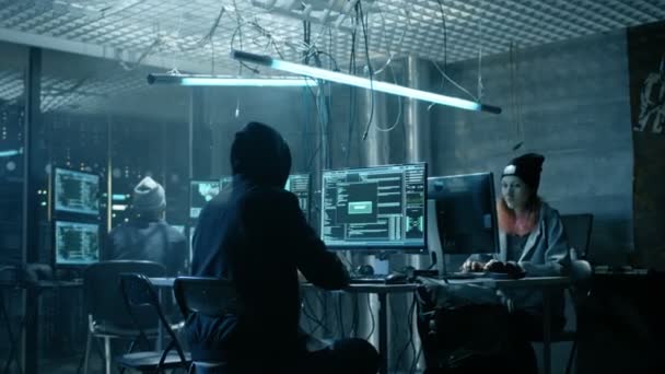Group of Teenage Hackers Organize Attack on Corporate Data Servers. Their Lair is Dark and Full of Operating Displays. — Stock Video