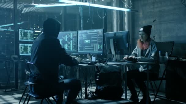 Team of Internationally Wanted Teenage Hackers Bring Advanced malware Attack on Corporate Servers. Place is Dark and Has Multiple displays. — Stock Video