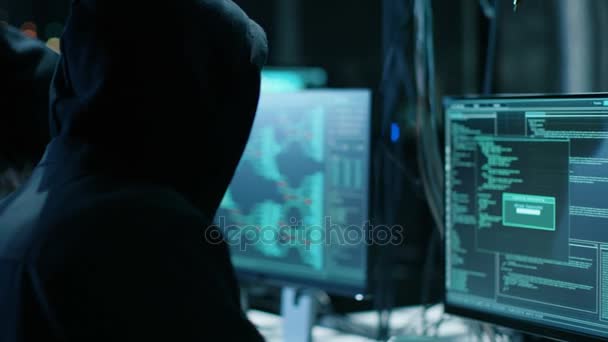 Tým mezinárodně hledaný chlapec a dívka hackeři organizovat rozšířené Virus útok na firemních serverech. Místo je tmavý a má více monitorů. — Stock video