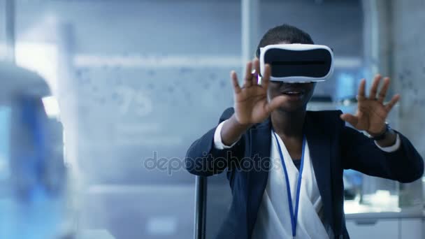 Young Black Female Virtual Reality Engineer/ Developer  Wearing VR Headset Creates Content. She's Alone in a Modern Laboratory/ Research Center. — Stock Video