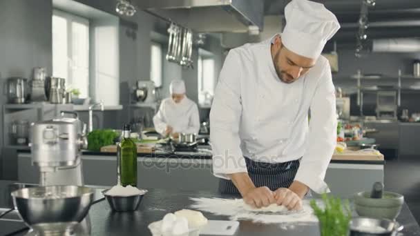 Baker Chef of Famous Restaurant Kneads the Dough in a Modern Looking Kitchen. — Stock Video