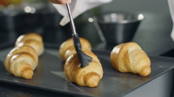Professional French Baker Butters Croissants. — Stock Video