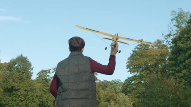 Boy Runs With Toy Airplane. Camera Following from Back. — Stock Video