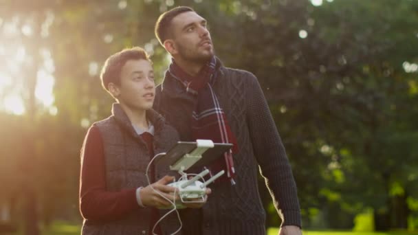 Πατέρας και γιος που τον έλεγχο Dron με τηλεχειριστήριο στο πάρκο — Αρχείο Βίντεο