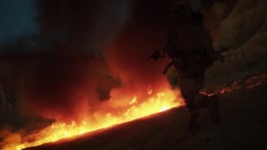 Grup silahlı asker ateşlerde gece askeri işlem sırasında çalışıyor. Ağır çekim.