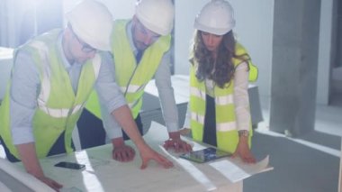 Grup mühendis bitti bükme büyük Blueprint ve konuşmayı, Bina yapım aşamasında içinde.