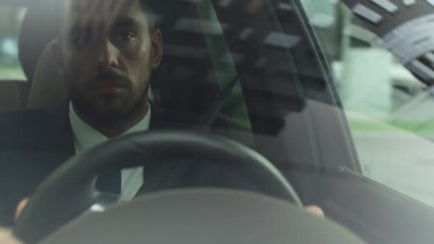 Businessman Driving a Car in Business District. Checking the Time. — Stock Video