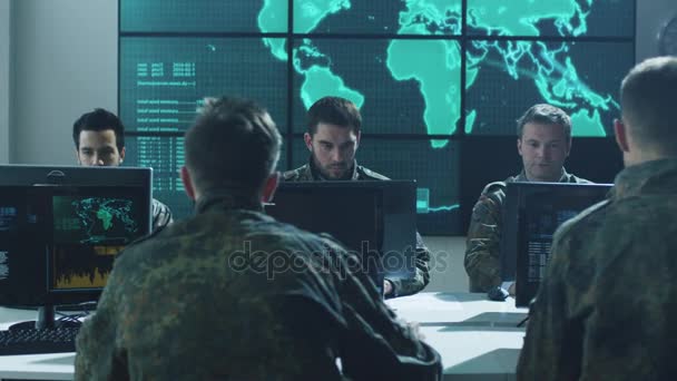 Group of Military IT Professionals in Monitoring Room Filled with Displays on Military Base — Stock Video