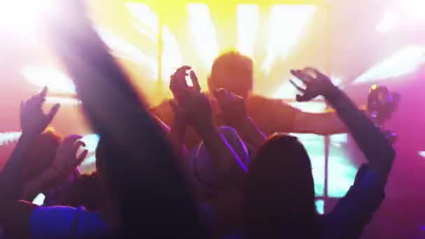 DJ Playing Music in Nightclub, People Dancing, Having Fun and Raising Hands. — Stock Video