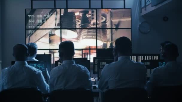 Group of People in Mission Control Center filled with Displays, Celebrating Successful Rocket Launch. Elements of this image furnished by NASA — Stock Video