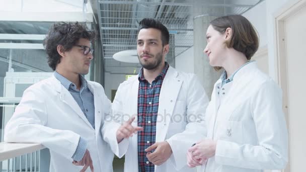 Grupo de Estudiantes de la Escuela de Medicina tienen reunión en el pasillo de la universidad. Tener conversación . — Vídeo de stock