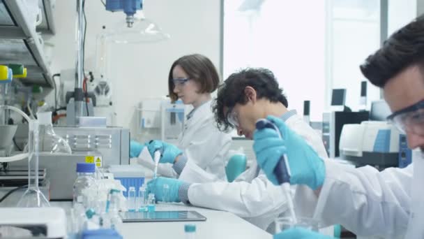 Team of Multiethnic Students in Coats Working in Laboratory of Chemistry Classroom. — Stock Video