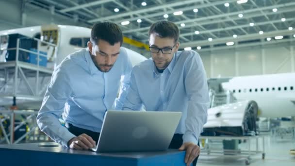 Twee vliegtuigen mechanica werken en die gesprek naast Laptop Computer — Stockvideo