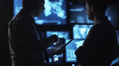İki erkek eleman karanlık bir izleme odada göstermek perde ile dolu bir konuşma yapıyoruz.