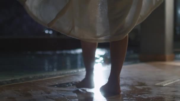 Young attractive female is dropping her towel before walking into pool in a spa wellness center. — Stock Video