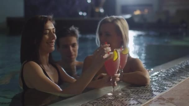 Group of friends are having fun while talking near a pool in a spa wellness center. — Stock Video