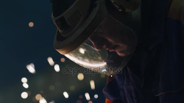 그는 금속 앵글 그 라인 더에 노력 하는 동안 반영 하는 마스크에 중공업 노동자의 불꽃. — 비디오