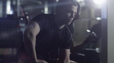 Uygun sportif yakışıklı ile spor salonunda ağır halter egzersiz.