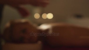 Çekici uygun genç bayan romantik bir atmosferde Spa'da rahatlatıcı bir masaj tedavi geçiriyor.