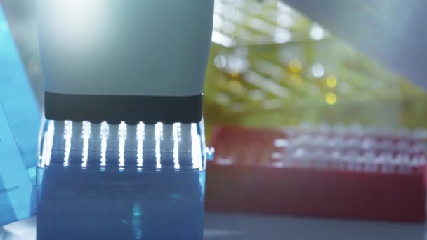 Close-up footage of a scientist adding liquid to test-tubes with a micro pipette in a laboratory. — Stock Video