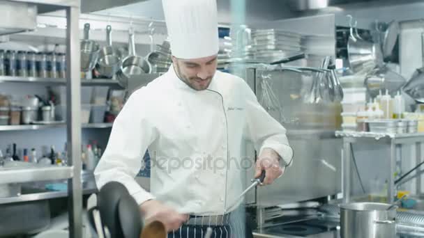 Chef profissional em uma cozinha comercial em um restaurante ou hotel está afiando facas . — Vídeo de Stock