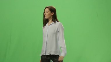 Kadın bir mock-up üzerinde sanal bir interaktif arayüz bastırıyor arka planda yeşil ekran.