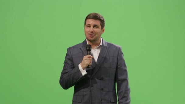 Media Reporter With A Microphone Is Talking On Mock Up Green Screen In The Media Reporter With A Microphone Is Talking On Mock Up Green Screen In The