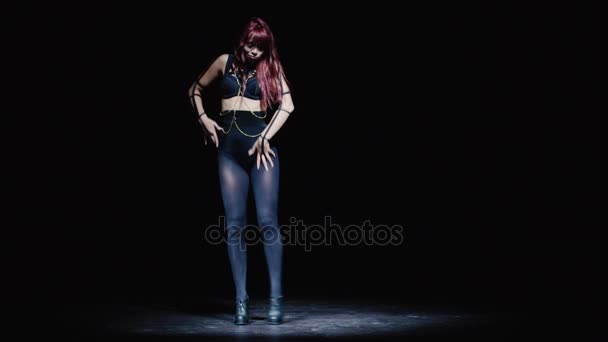 Kaukasisches Mädchen in dunklen Kleidern, das auf einer dunklen Bühne einen zeitgenössischen Tanz mit einem Kuss aufführt. — Stockvideo