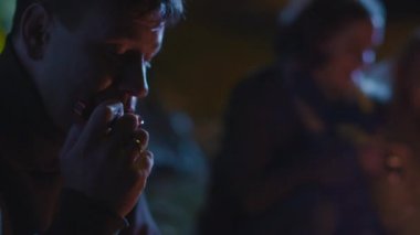 Bir grup arkadaşıyla dinliyor iken komuta sizde bir mızıka kamp ateşi yanında üzerinde gece oynuyor.