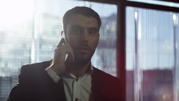 Retrato de un hombre de negocios caminando y hablando por teléfono . — Vídeos de Stock