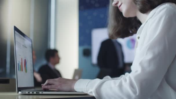 Бізнесмен працює на ноутбуці під час презентації в конференц-залі — стокове відео
