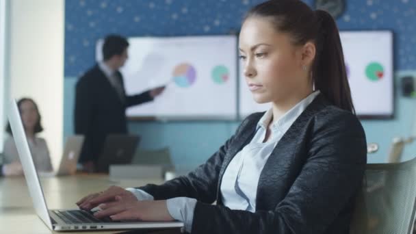Бізнес жінка працює на ноутбуці під час презентації в конференц залі . — стокове відео