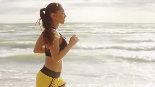 Girl is Running at Morning Time in Beach. Um tiro lateral. Movimento lento . — Vídeo de Stock