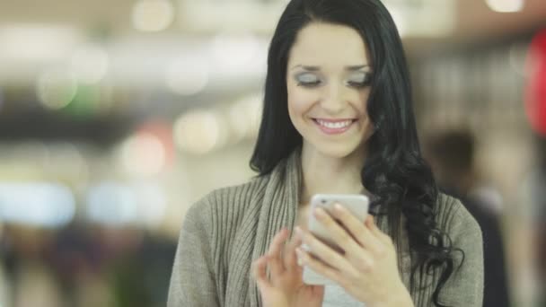 Chica joven con sonrisa perfecta está utilizando el teléfono móvil. Ciudad Estilo de vida . — Vídeos de Stock