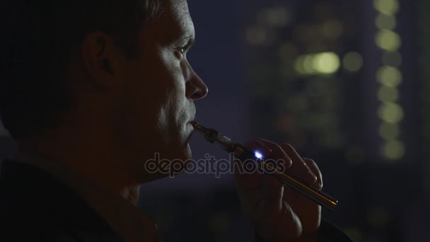 男は、夜の電子タバコを吸って — ストック動画