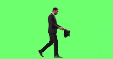 İş takım elbiseli adamı şemsiye yürürken açılır. Mock-up üzerinde atış yeşil ekran.