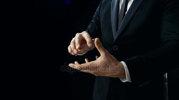 Close-up of a Magician's Hands Performing Card Trick. Throwing and Catching Cards Deck in the Air. Background is Black. Slow Motion. — Stock Video