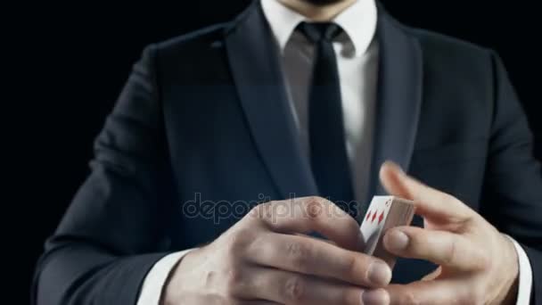 Close-up of a Suited Magician's Hands Performing Sleight of Hand Card Tricks. Background is Black. — Stock Video