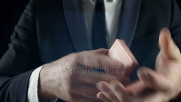 Close-up of a Suited Magician's Hands Performing Sleight of Hand Card Tricks. Background is Black. — Stock Video