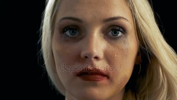 Close-up Shot Sad Crying Bruised Blonde Woman Looking Down and Then Into the Camera. Violence Theme. Background is Isolated Black. — Stock Video