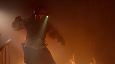 Brave Firefighter With Switched On Flashlight on His Helmet Runs clipart