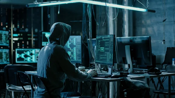Hooded Hacker Using His Comuter with Different Information to Br — Stock Photo, Image