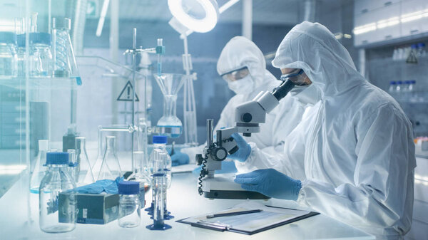 In a Secure High Level Laboratory Scientists in a Coverall Condu