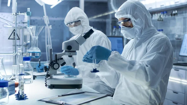 Em um laboratório de alto nível seguro Cientistas em uma Coverall Condu — Fotografia de Stock