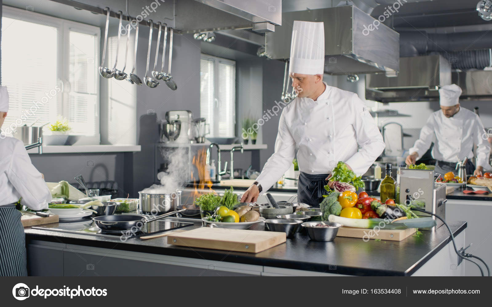 Famous Chef Works in a Big Restaurant Kitchen with His Apprentic