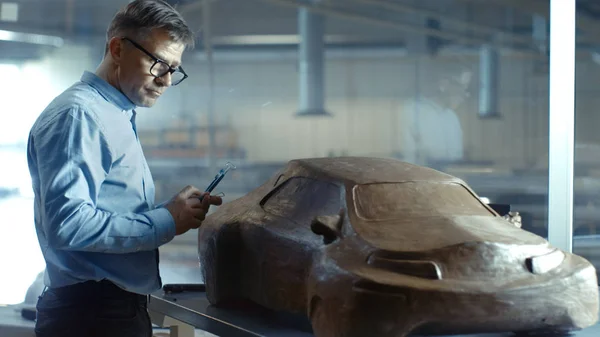 Chief Automotive Designer with Rake Sculpts Futuristic  Car Mode