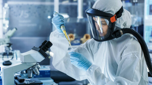 Medical Virology Research Scientist Works in a Hazmat Suit with 