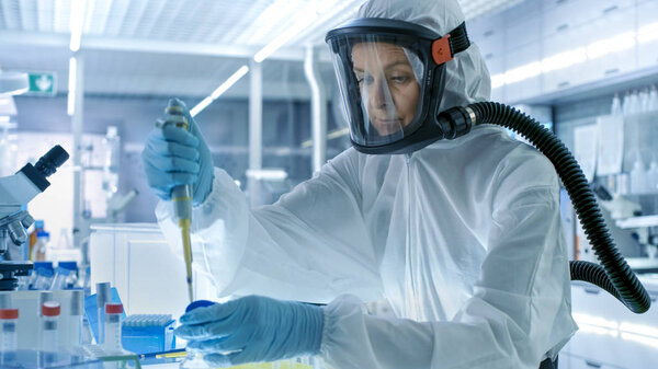 Medical Virology Research Scientist Works in a Hazmat Suit with 